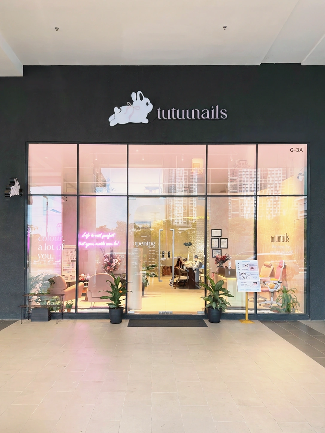 Tutuunails storefront at Kiara Bay with rabbit signage, glass doors and a warmly lit interior